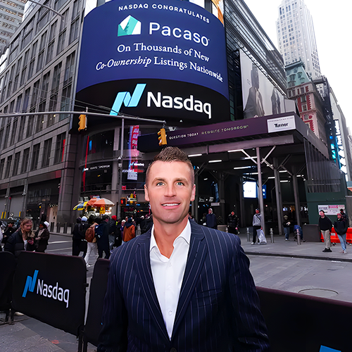 Pacaso co-founder standing in front of the NASDAQ in NYC
