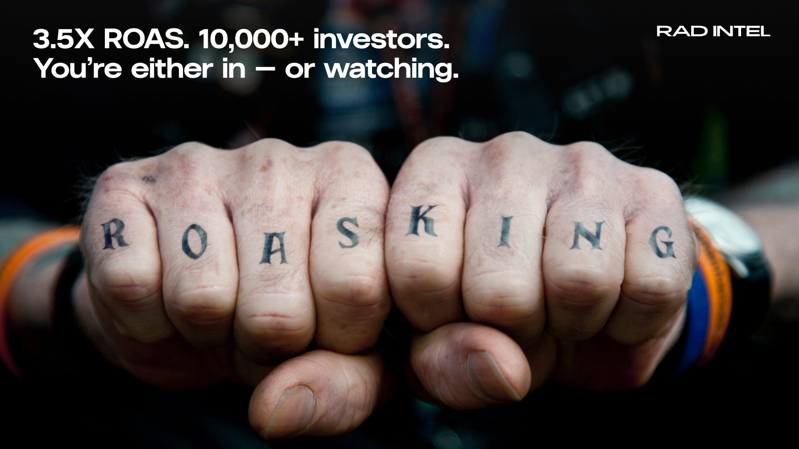 Someone's fists with knuckles showing, with the fingers tatooed with 'ROAS KING', one letter on each finger.